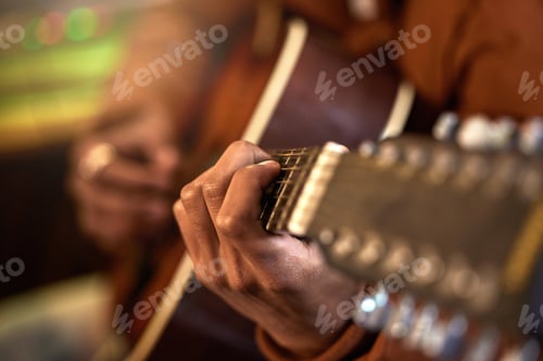 Preview: Fingers on the chords. Cropped shot of an unrecognizable male musician playing his guitar at home.