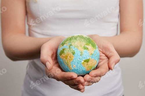 Preview: woman holding planet model on grey background, earth day concept