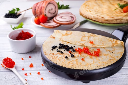 Preview: Pancakes with red caviar on plate.