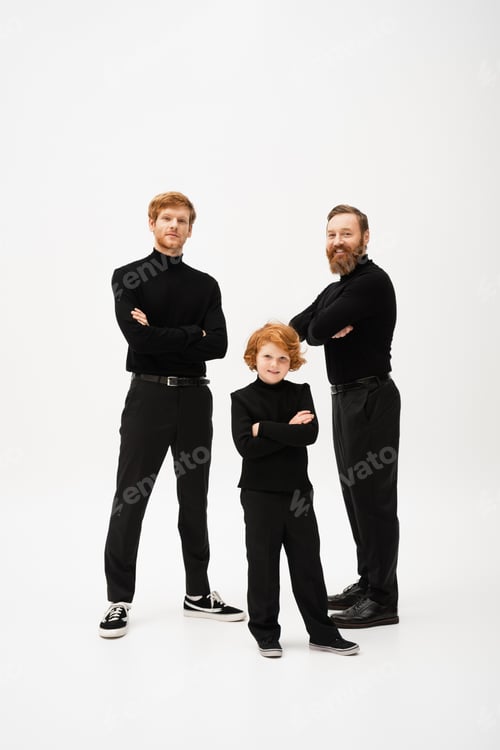 Preview: full length of red haired kid with father and bearded granddad in black clothes standing with