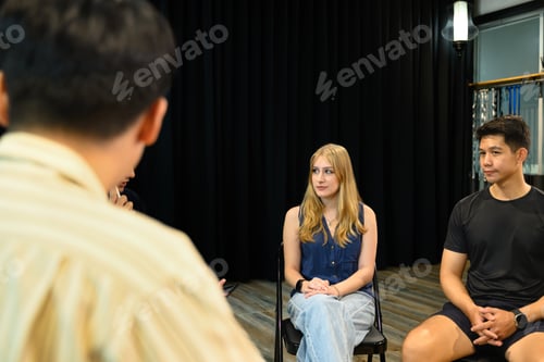 Preview: Group therapy session with diverse participants seated, listening attentively to each other