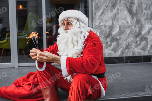 Preview: santa claus holds sparklers in her hands