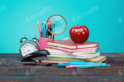 Preview: Back to School concept. Books, colored pencils and clock