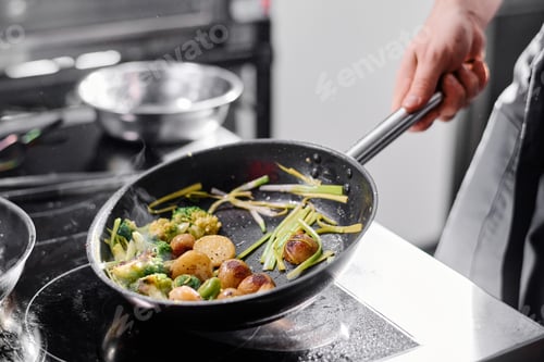 Preview: Cook frying vegetables on pan