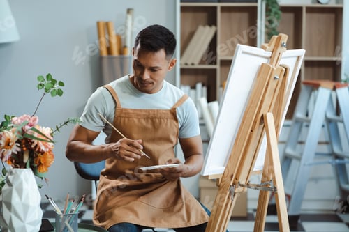 Preview: Male artist painting on canvas in the home studio, fine arts and creativity concept.
