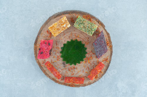 Preview: A small assortment of turkish delights on the board,on the marble background