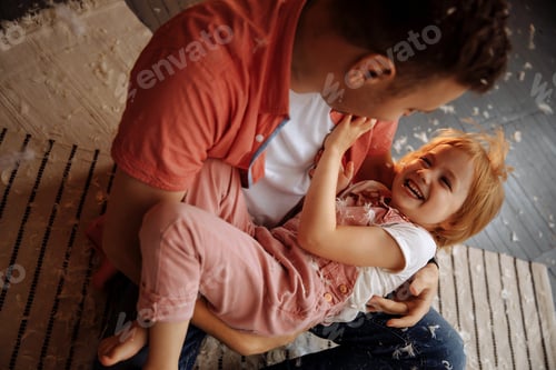 Preview: Father and Child Playfully Interact in Home Setting
