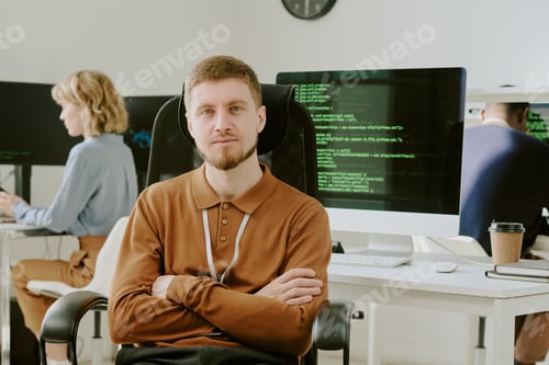 Preview: Young Programmer Sitting At Workplace