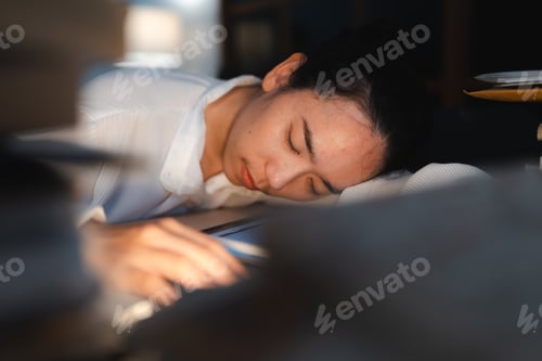 Preview: Late-night freelancer, Dedicated Asian woman working overtime on laptop computer, meeting deadlines