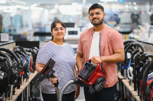 Preview: Indian Couple choosing vacuum cleaner, electronics store