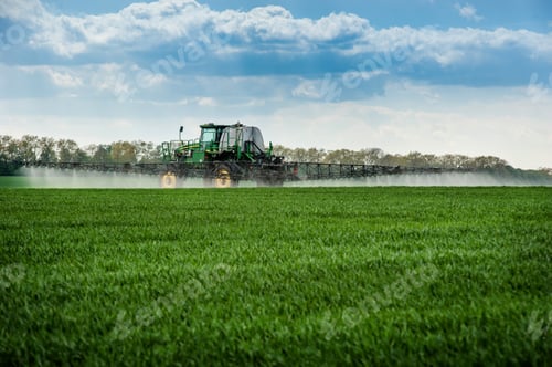 Preview: Sprayer with fertilizers on agricultural green fields in spring
