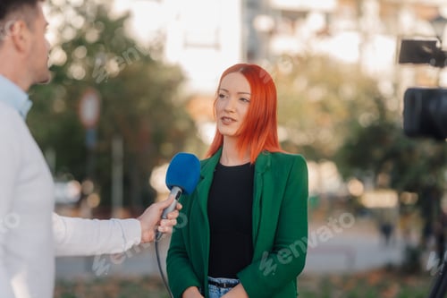 Preview: Journalist interviewing businesswoman with red hair outdoors