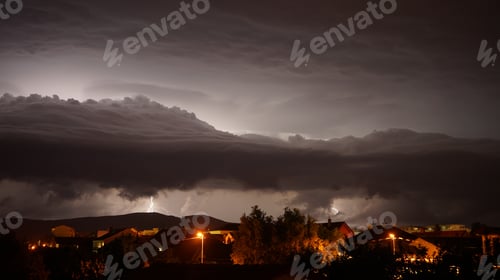Preview: Dark stormy night sky above houses and mountains