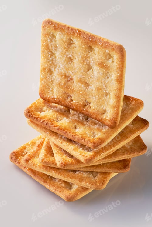 Preview: A pile of seven sweet crackers with one standing on top