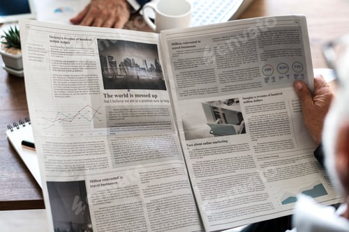 Preview: Business people reading newspaper