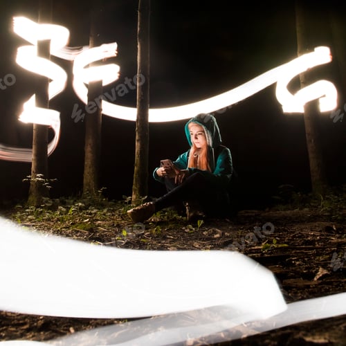 Preview: Young Girl Using Mobile Phone in Magical Forest