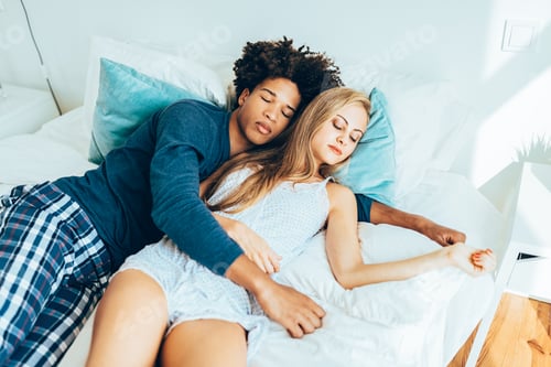 Preview: Young beautiful interracial couple in bed sleeping