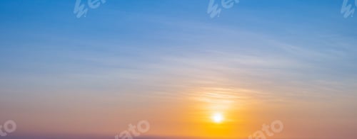 Preview: Sunset sky scene with a bright golden light. Beautiful sunrise with clouds soft.