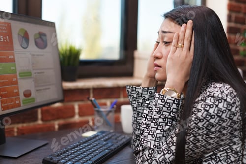 Preview: Fatigued office worker suffering from overtime working while having migraine headache