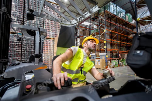 Preview: Warehouse worker in a forklift truck places the packages on the shelves