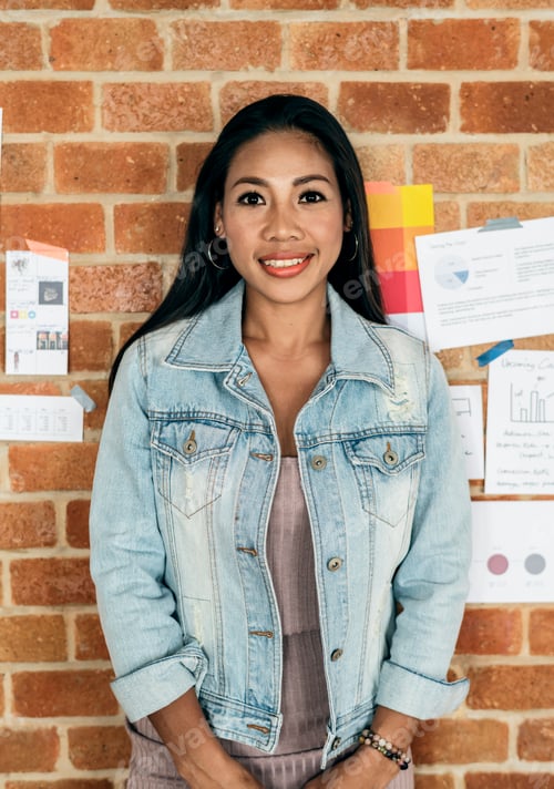 Preview: Portrait of Asian woman with brick wall