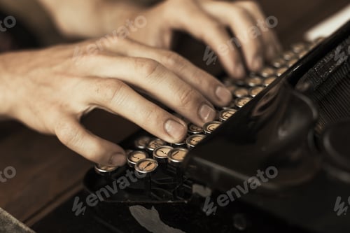 Preview: Young man's hands typing on an antique vintage typewriter