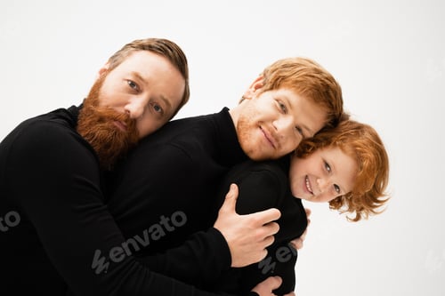 Preview: happy bearded man hugging redhead son and grandson in black sweaters isolated on grey