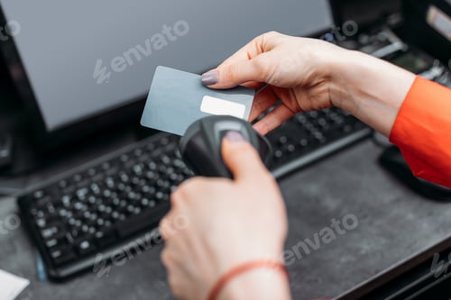 Preview: Close-up partial view of person using payment terminal and scanning credit card