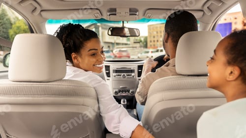 Preview: Back View Of African Family Riding Car In Urban Area