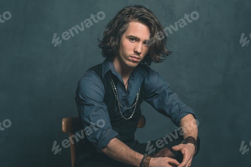 Preview: Vintage Alternative Artistic Fashion Man. Sitting On Wooden Chair In Studio.