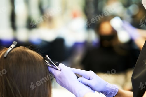Preview: Adult woman at hairdresser wearing protective mask due to coronavirus pandemic