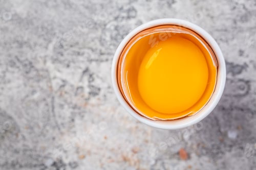 Preview: Raw egg in a eggcup on kitchen table