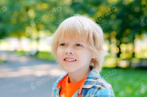 Preview: Cute blond caucasian little girl sitting on a bench in the park. Child development