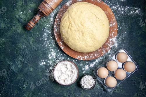Preview: top view raw dough with white flour and eggs on a dark-blue background pastry bake cake raw oven