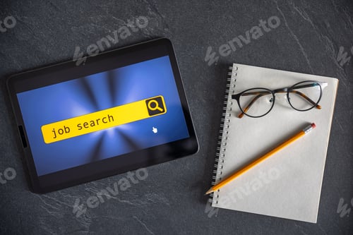 Preview: Top view of digital tablet with search job on screen on a table.