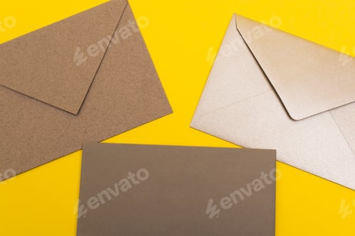 Preview: top view of paper envelopes isolated on yellow