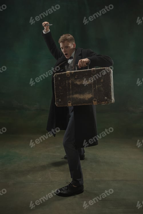 Preview: Young man in art action isolated on dark green background. Retro style, comparison of eras concept
