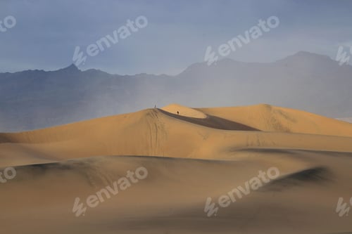 Preview: Sandy desert dune, with the view of the majestic mountains in the horizon