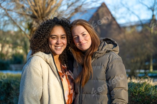 Preview: Two friends sharing a joyful moment outdoors.