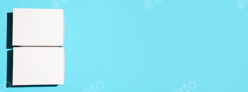 Preview: Two white cardboard boxes mock up on blue background, flat lay. Banner, empty space for logo