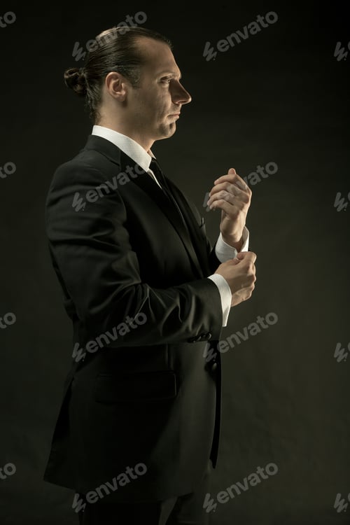 Preview: The Attractive Man In Black Suit On Dark Background