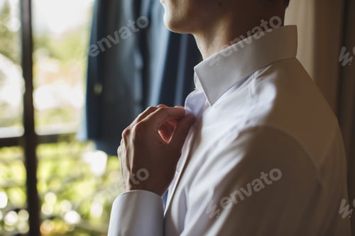 Preview: Man Fastening Buttons on White Shirt Indoors