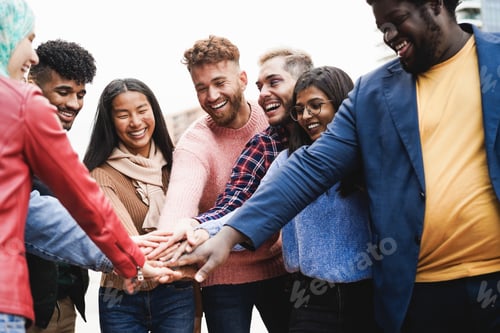 Preview: Young diverse team having fun stacking hands outdoor - Focus on asian girl face
