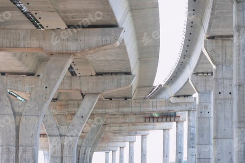 Preview: Structure flyover foundation posts under construction against white lacking sky