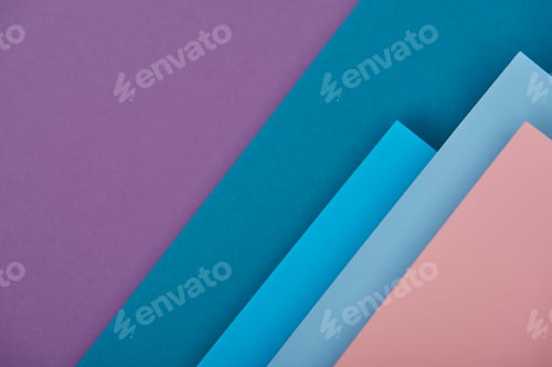 Preview: top view of purple, blue and pink paper sheets with copy space