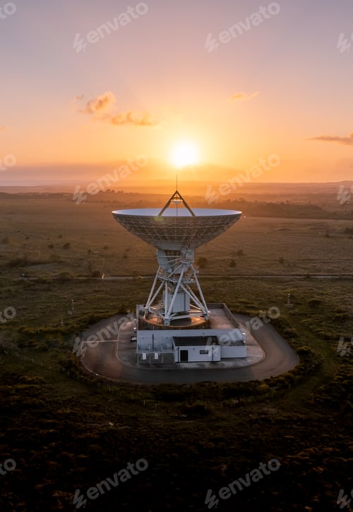 Preview: A satellite dish pointing skywards at sunset