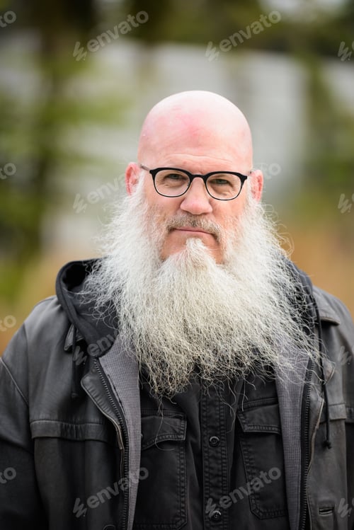 Preview: Face of mature bald bearded man with eyeglasses