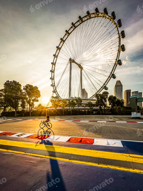 Preview: Picture perfect end of the day! A cyclist riding by Singapore Flyer at sunset.