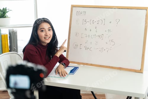 Preview: Asian school woman teacher working from home teaching online math subject to student.