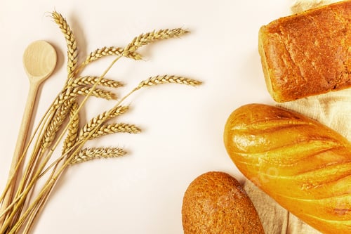 Preview: Ears of ripe wheat and three different loaves of bread